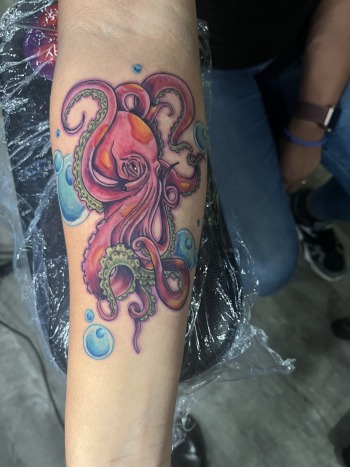 Octopus colored animal tattoo by Paper Airplane Jane at Iron Palm Tattoos & Body Piercing in downtown Atlanta, GA. We're open late night until 2AM during the week. Call 404-973-7828 or stop by for a free consultation.