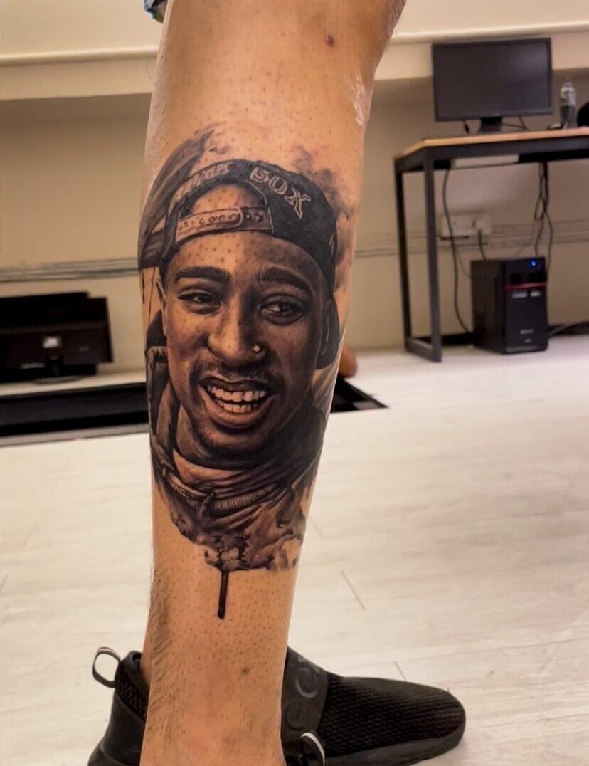 Tupac Shakur tattoo by body artist Choze at Iron Palm Tattoos & body Piercing in downtown Atlanta. Portrait & memorial tattoos are our thing. Walk-ins welcome. Call 404-973-7828 or visit for a free consultation.