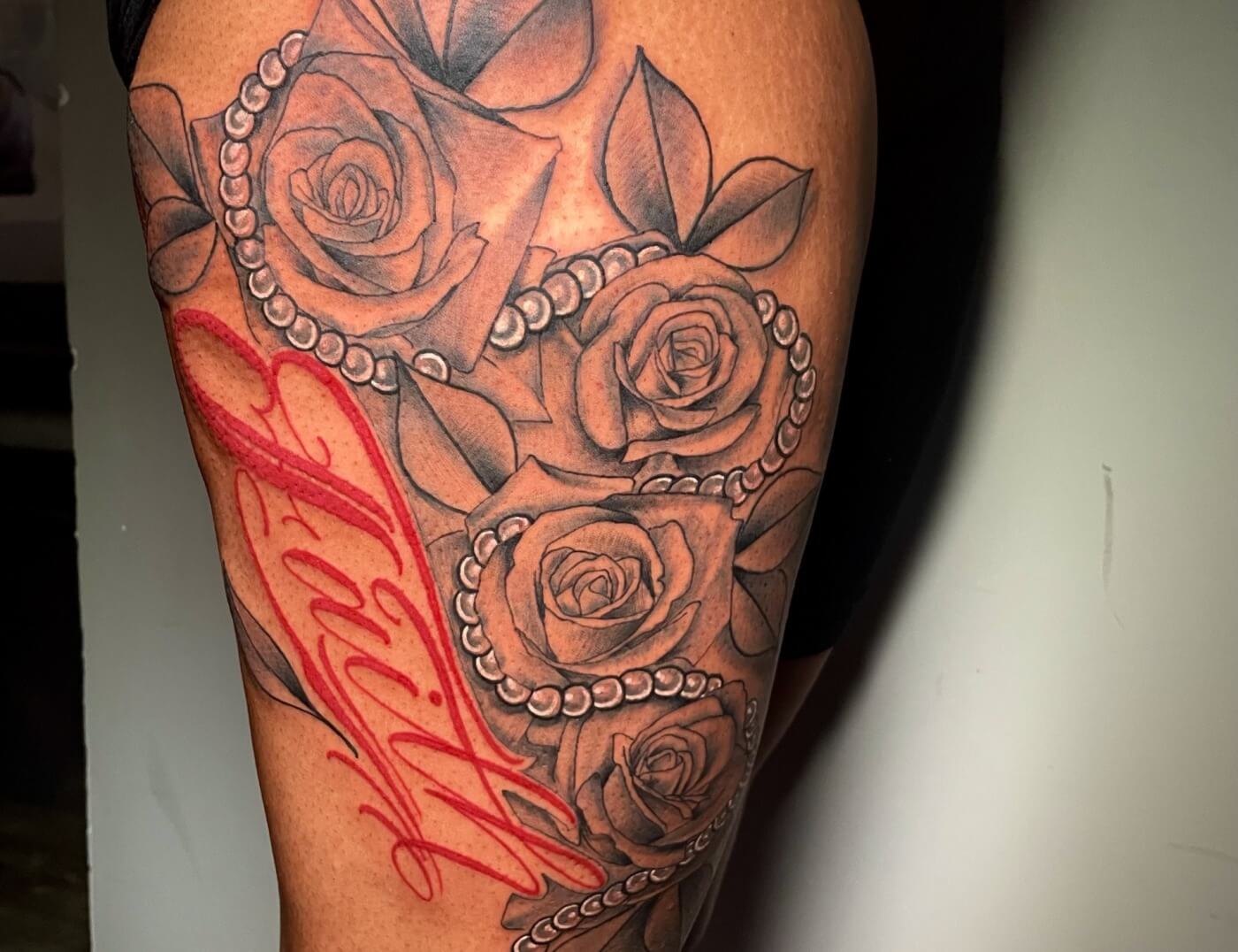 Beautiful red floral script tattoo (lettering) by Lyric The Artist at Iron Palm Tattoos & Body Piercing in downtown Atlanta, GA. Lyric is one of the most creative tattoo artists in the southeastern United States. We're open late night til 2AM most nights. Call 404-973-7828 or stop by for a free consultation. Walk-Ins are welcome.