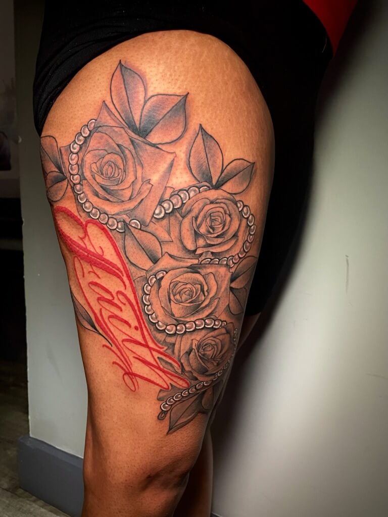 Beautiful red floral script tattoo (lettering) by Lyric The Artist at Iron Palm Tattoos & Body Piercing in downtown Atlanta, GA. Lyric is one of the most creative tattoo artists in the southeastern United States. Call 404-973-7828 or stop by for a free consultation. Walk-Ins are welcome.