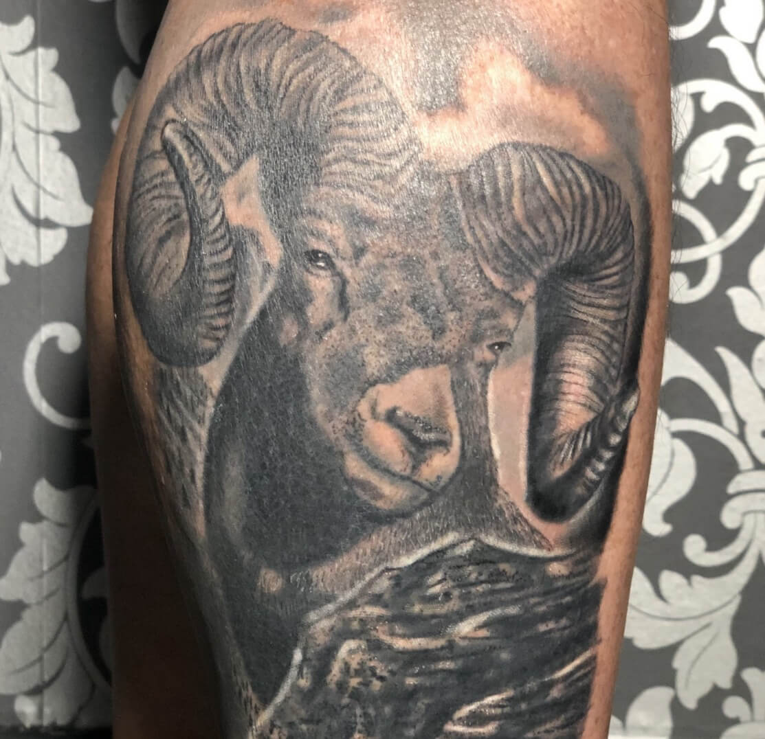 Ram animal tattoo in black and grey by DB. Wyte of Iron Palm Tattoos & Body Piercing in Atlanta, GA. Call 404-973-7828 or stop by for a free consultation to book DB Wyte.