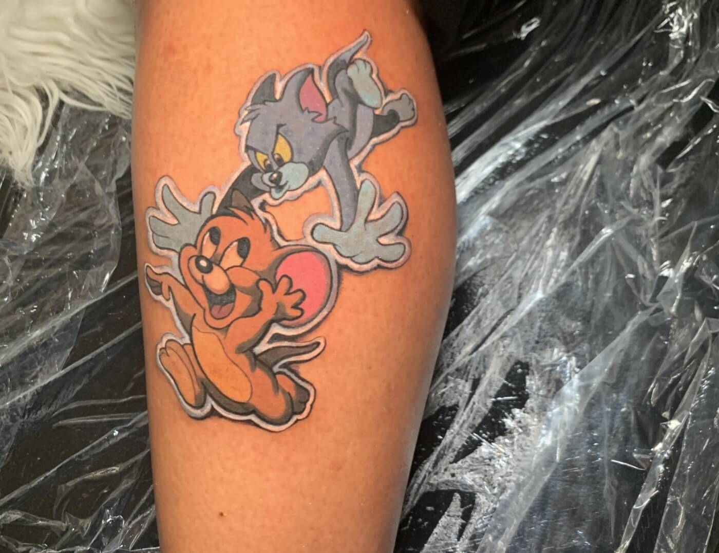 Tom & Jerry Cartoon anime tattoo by J.R. Outlaw of Iron Palm Tattoos. Tom & Jerry are classic americana and we get more than a few requests to ink these animated legends. We're open late night until 2 AM most nights. Call 404-973-7828 or stop by for a free consultation.