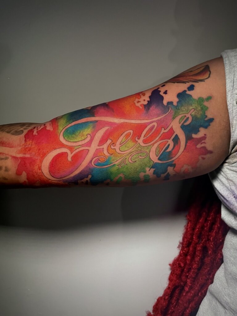 Water color script lettering tattoo designed and inked by Lyric The Artist at Iron Palm Tattoos & Body Piercing in Atlanta, GA.