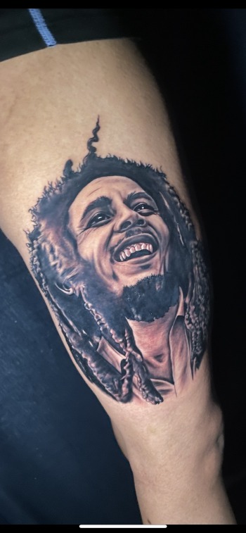 Bob Marley Photo Realism Portatif & Memorial tattoo by T Sawyer of Iron Palm Tattoos & Body Piercing. Walk Ins accepted. Call 404-973-7828 or stop by for a free consultation.