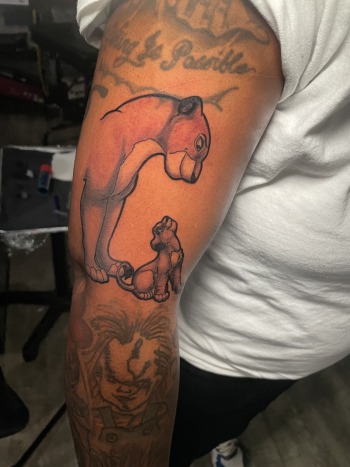 Sarabi & Simba Animal Anime Tattoo by Body Artist T Sawyer at Iron Palm Tattoos & Body Piercing in downtown Atlanta, Georgia. Call 404-973-7828 or stop by for a free consultation. Walk Ins are welcome.