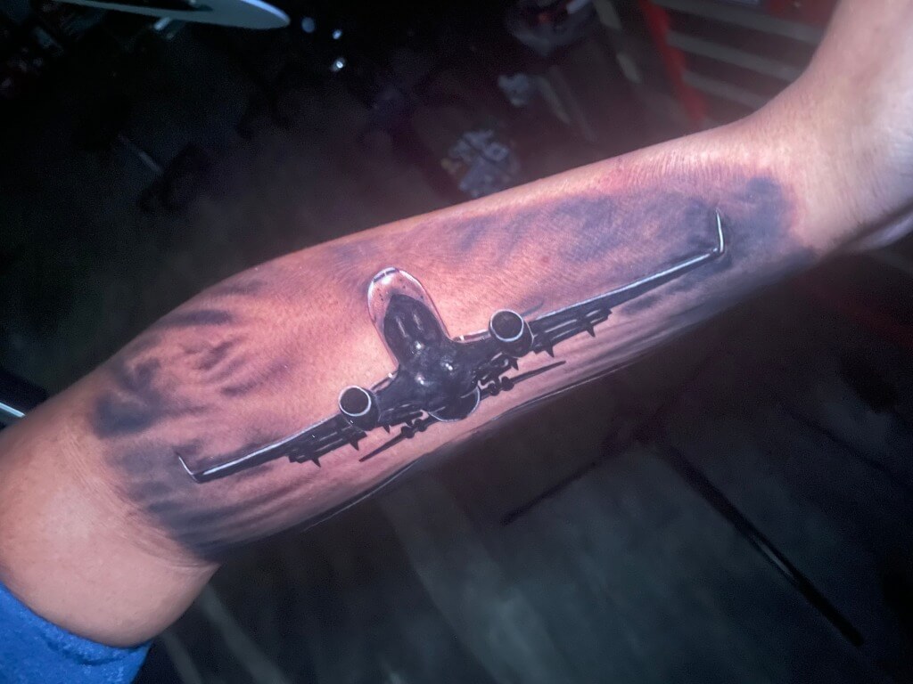 Commercial Jet Airline Colored Photo-realistic Tattoo by tattooist Terrance Sawyer At Iron Palm Tattoos In Downtown Atlanta. Call 404-973-7828 or stop by for a free consultation.