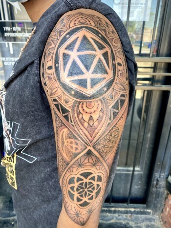 Geometric Mandala tattoo by Lyric The Artist at Iron Palm Tattoos in south downtown Atlanta. Mandala tattoos have their origins in Hindu and Buddhist cultures, where mandalas are used as spiritual and ritual symbols. The word "mandala" comes from Sanskrit and means "circle" or "center." What do you think? Let us know in the comments. Iron Palm is open late night until 2AM. Call 404-973-7828 or stop by for a free consultation.