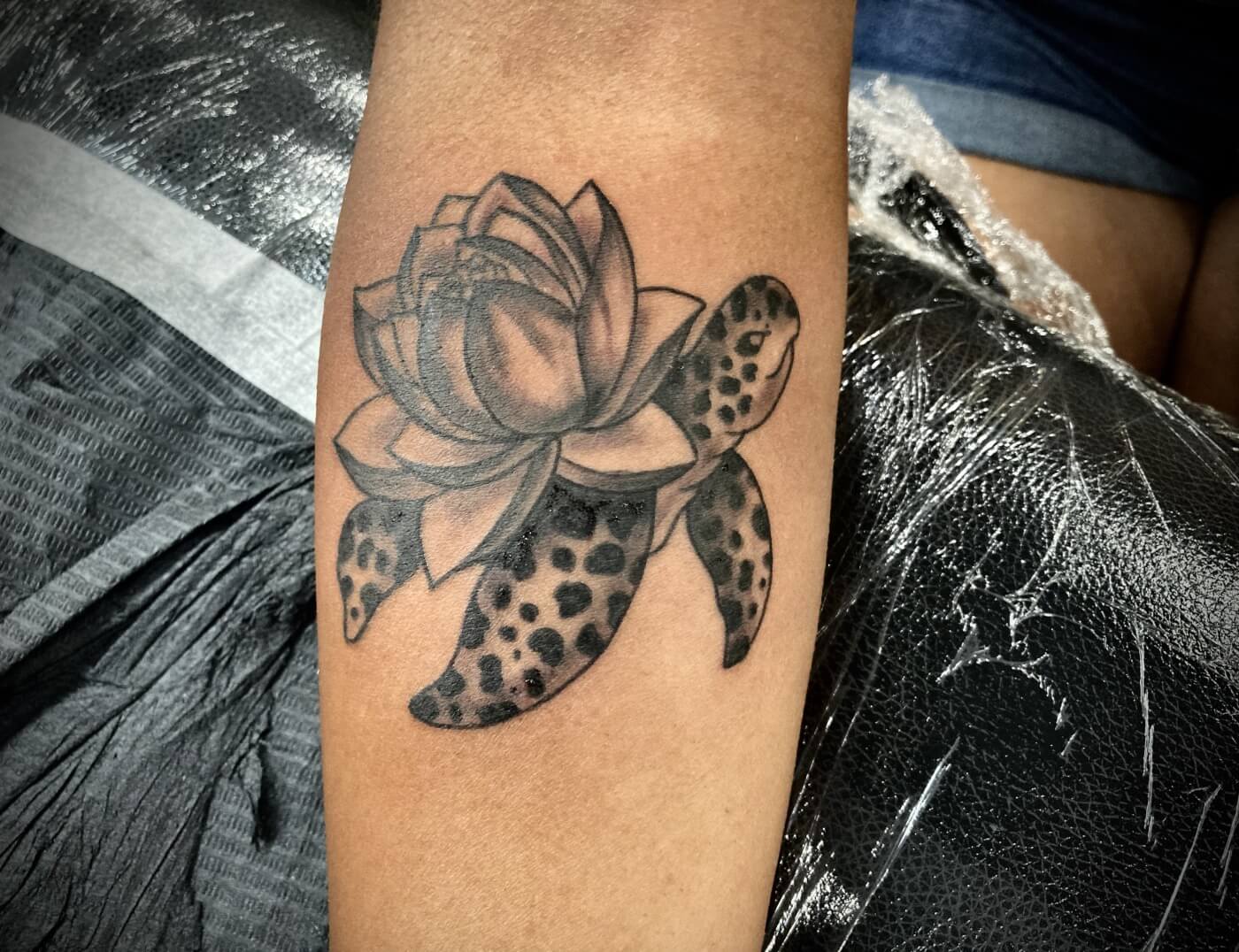American Traditional Turtle With Lotus Shell In Black & Grey By Funk Tha World. At Iron Palm Tattoos. Call 404-973-7828 or stop by for a free consultation. Walk Ins are welcome.
