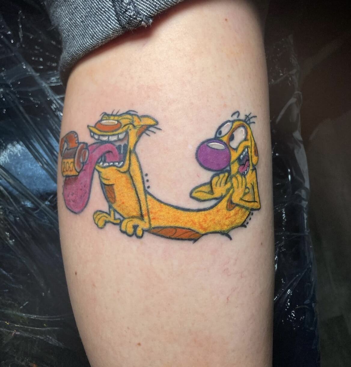 "CatDog" Cartoon Anime Tattoo by Funk Tha World for Jordan Ulm At Iron Palm Tattoos In downtown Atlanta, Georgia. CatDog is a popular animated television series that aired in the late 1990s to early 2000s,. People tend to get the tattoo as a reference to the era they grew up in. Others relate to the character of CatDog, which is a hard to imagine hybrid of a cat and dog. The character embodies the idea of being different or not fitting into a specific category, Getting a CatDog tattoo is a way for people to express their own individuality and embrace their quirks. Call 404-973-7828 or stop by for a free consultation with Funk or another Iron Palm body artist . Walk ins are welcome. #catdoglover #catdogtattoo #catdogcartoon #atlanta #atlantatattoo #atlantatattooshop #atlantatattooartist #atlantatattoostudio #tattoo #tattooshop #tattooart #tattoodesign #animetattoo #animetattooideas #animetattooers #cartoonart #cartoontattoo