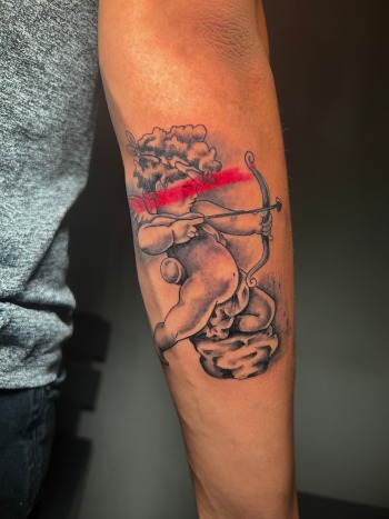 Cupid Black & Grey Tattoo By Funk Tha World At Iron Palm Tattoos. Call 404-973-7828 or stop by for a free consultation with Funk.