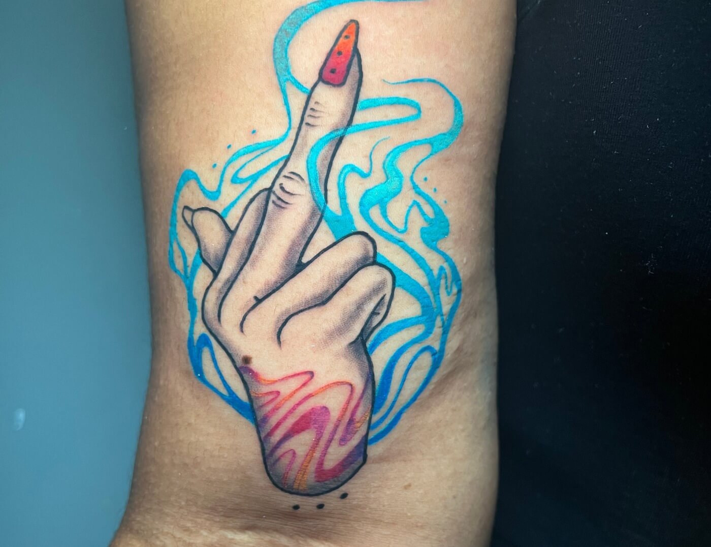 Funky Middle Finger Tattoo With Water Colors By Funk Tha World At Iron Palm Tattoos in downtown Atlanta's Castleberry Art district. Funk specializes in color tones and clean or fine line tattooing on any color tone. Call 404-973-7828 or stop by for a free consultation with Funk or any Iron Palm body artist. Walk Ins are welcome during our business hours.