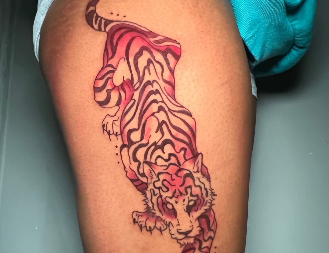 Red Tiger Tattoo By Funk Tha World at Iron Palm Tattoos In Atlanta. Combining the color red with a tiger tattoo signifies the intensity of the tiger's strength and the passion of the person wearing the tattoo.We're open late night until 2AM. Call 404-973-7828 or stop by for a free consultation.
