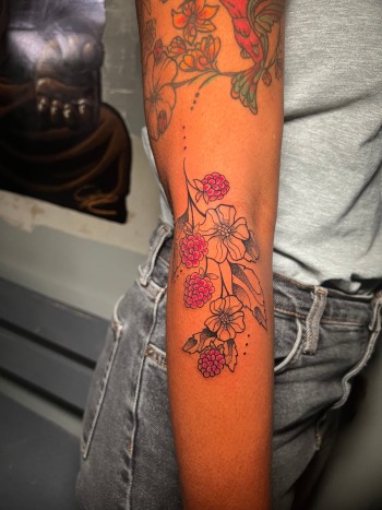 Raspberry Branch Tattoo With Red Color By Funk Tha World. Call 404-973-7828 or stop by for a consultation with Funk. Walk Ins are welcome.
