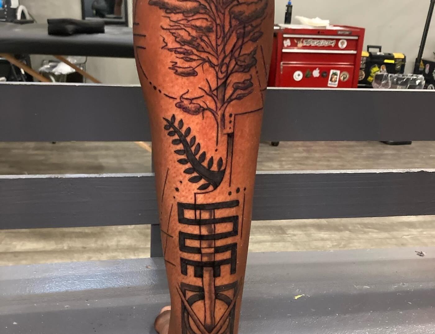 Tree Of Life With Adrinka Symbols Tattoo In Black & Grey By Funk Tha World At Iron Palm Tattoos. Call 404-973-7828 or stop by for a free consultation with Funk. Walk ins are welcome.