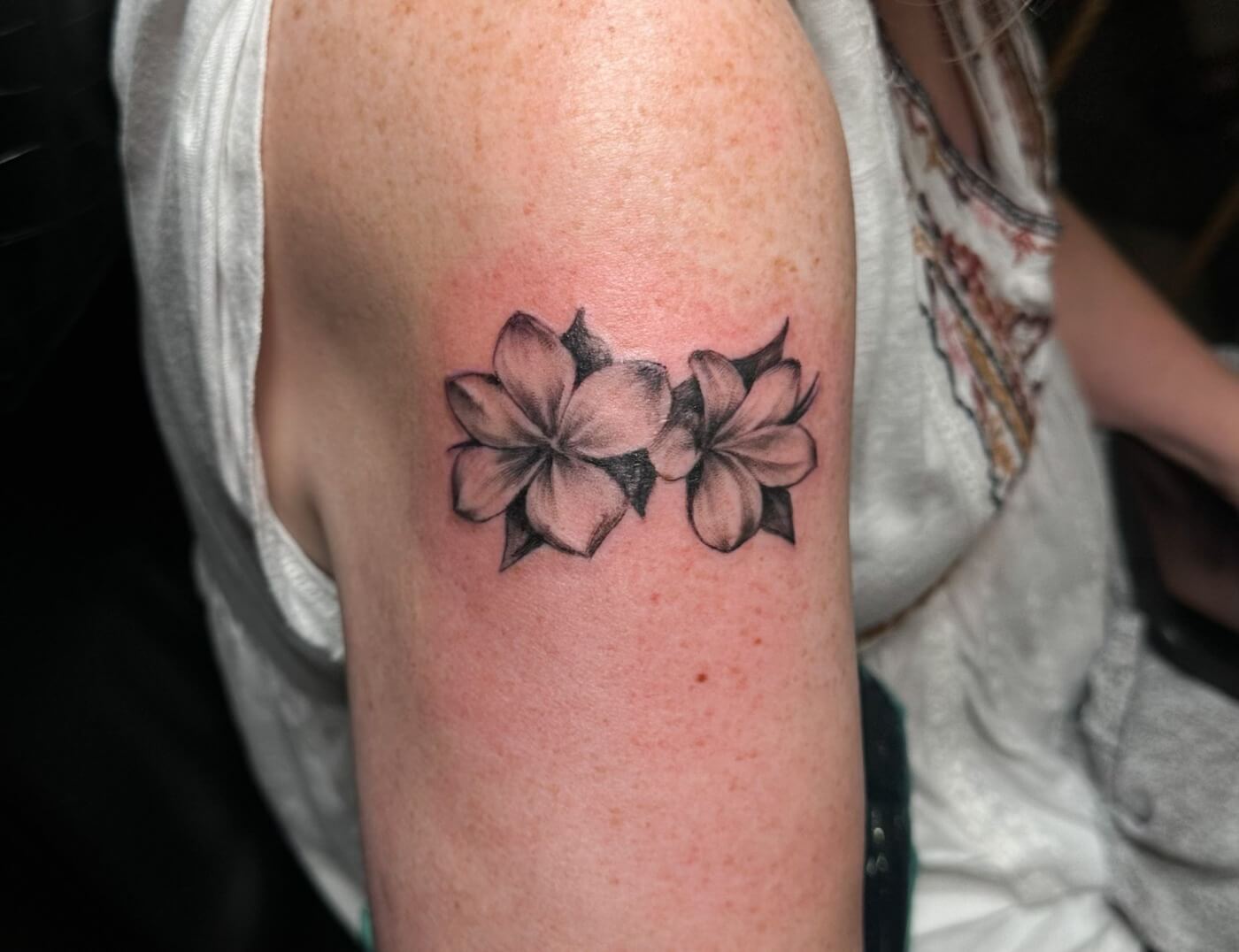 Black & Grey Apple Blossom Floral Tattoo By Choze At Iron Palm Tattoos. Call 404-973-7828 for a free consultation with Choze. We're open late night until 2AM most nights. Walk ins are welcome.