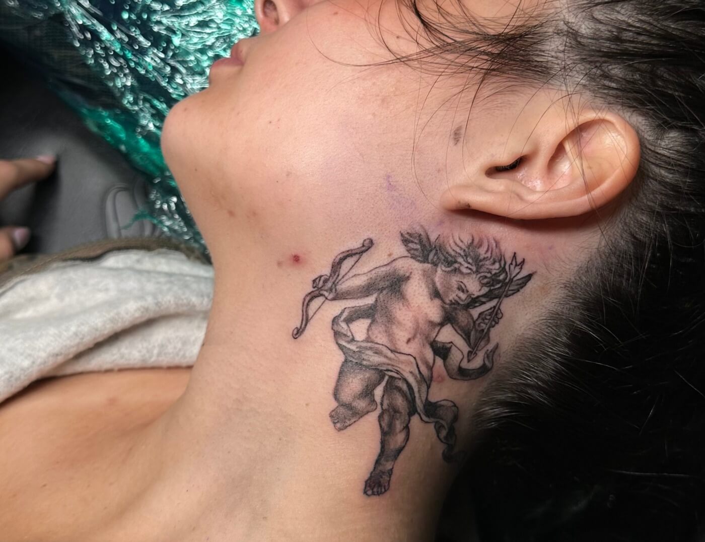 "Cupid Looking" Black & Grey Tattoo By Choze At Iron Palm Tattoos in Atlanta. Customers get cupid tattoos to signify the romanticism inside. Call 404-973-7828 or stop by for a free consultation with Choze or another body artist. Walk ins are welcome..