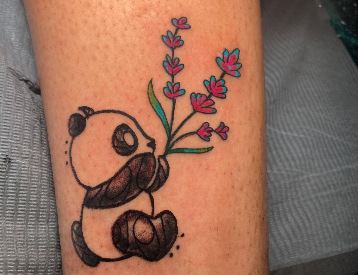 Panda Running With Flowers By Funk Tha World At Iron Palm Tattoos In Atlanta, Georgia. Call 404-973-7828 or stop by for a free consultation with Funk. Walk ins are welcome.