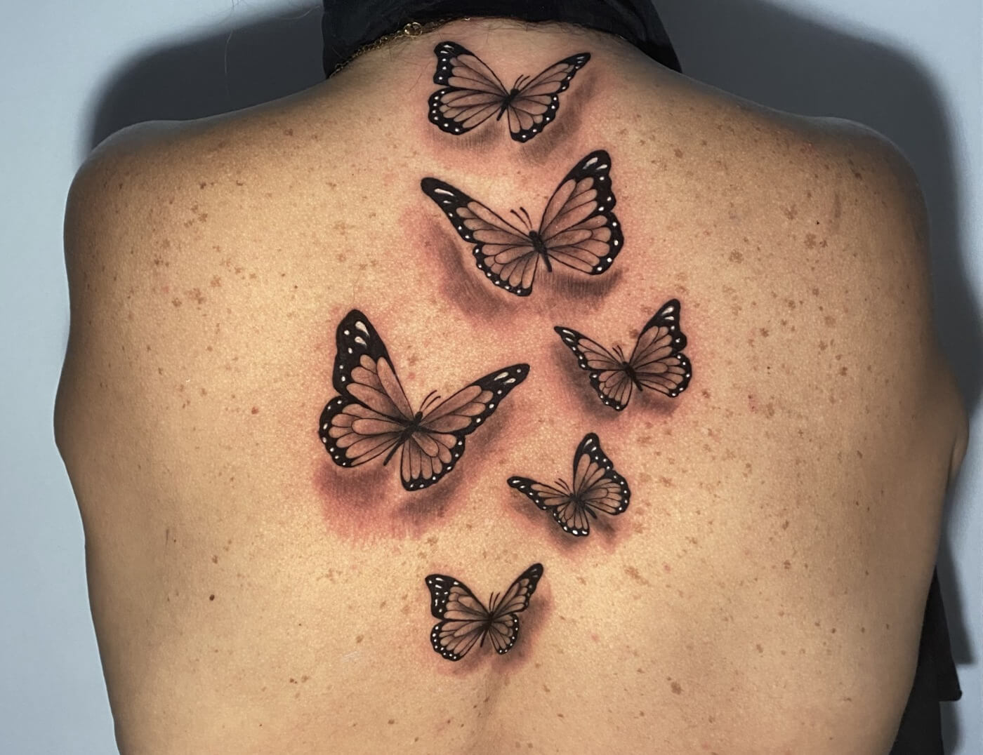 Butterfly Black & Grey Back Tattoo by Rene Cristobal, A guest Artist At Iron Palm Tattoos. Butterfly tattoos are poplar representations of growth and change. Call 404-973-7828 or stop by for a free consultation. Walk ins are welcome.