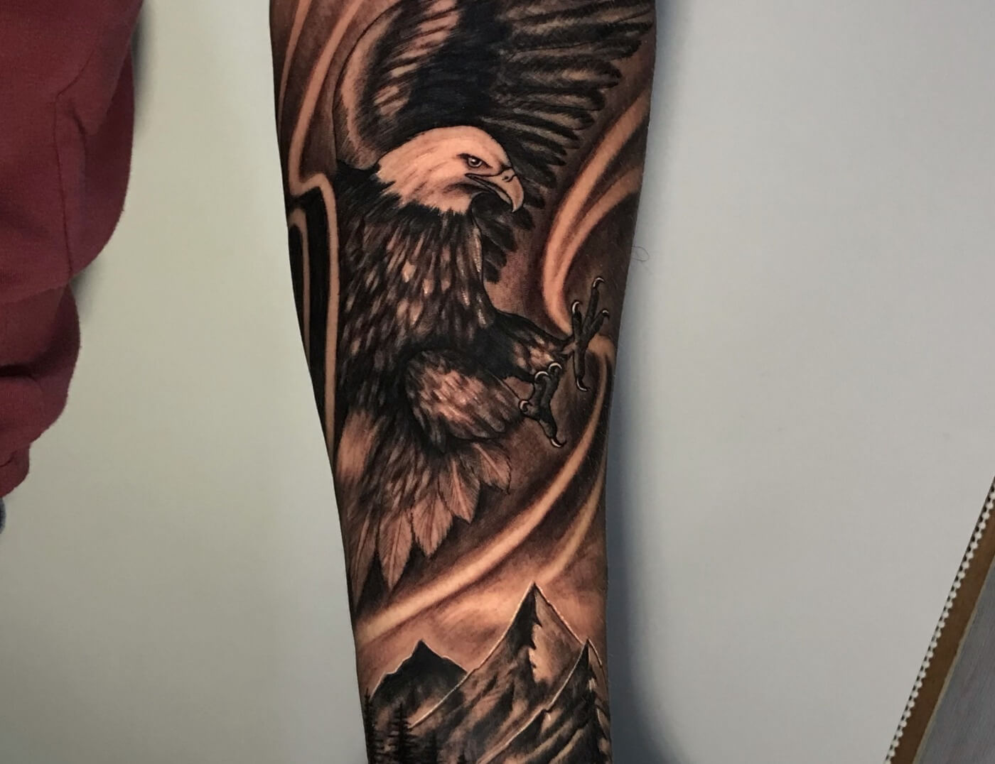 Eagle Soaring Over Mountains Black & Grey Photo Realism Tattoo By Rene Cristobal. Rene is a guest artist from Vision Tattoo Studio in Concepcion, Chile. He is available for booking July 3rd - 16th. We're open late night until 2AM. Call 404-973-728 or stop by for a free consultation.