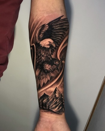 Eagle Soaring Over Mountains Black & Grey Photo Realism Tattoo By Rene Cristobal. Rene is a guest artist from Vision Tattoo Studio in Concepcion, Chile. He is available for booking July 3rd - 16th. We're open late night until 2AM. Call 404-973-728 or stop by for a free consultation.