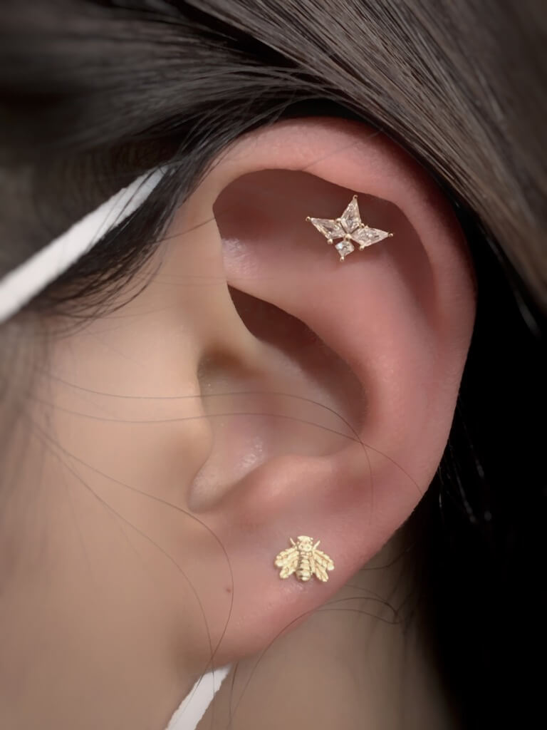 A faux rook piercing is a body piercing that simulates the look of a rook piercing. It consists of two piercings instead of one. The piercer will pierce the cartilage above and below the rook ridge. The piercing is done with a straight barbell, instead of the usually curved barbell used to pierce the rook.