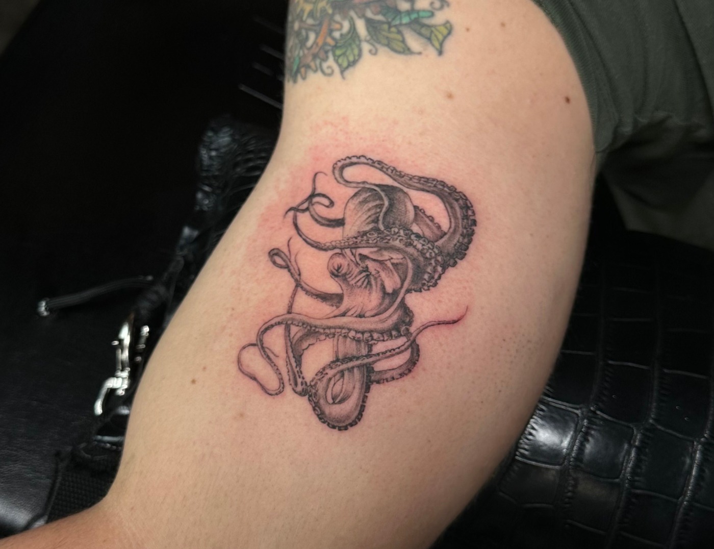 Octopus Black & Gray Realism Tattoo By Choze At Iron Palm Tattoos In Atlanta. Octopus tattoos symbolize knowledge and multitasking. Over the years it has also become a symbol for facing fears. We're open late night until 2AM most nights. Call 404-973-7828 or stop by for a free consultation.