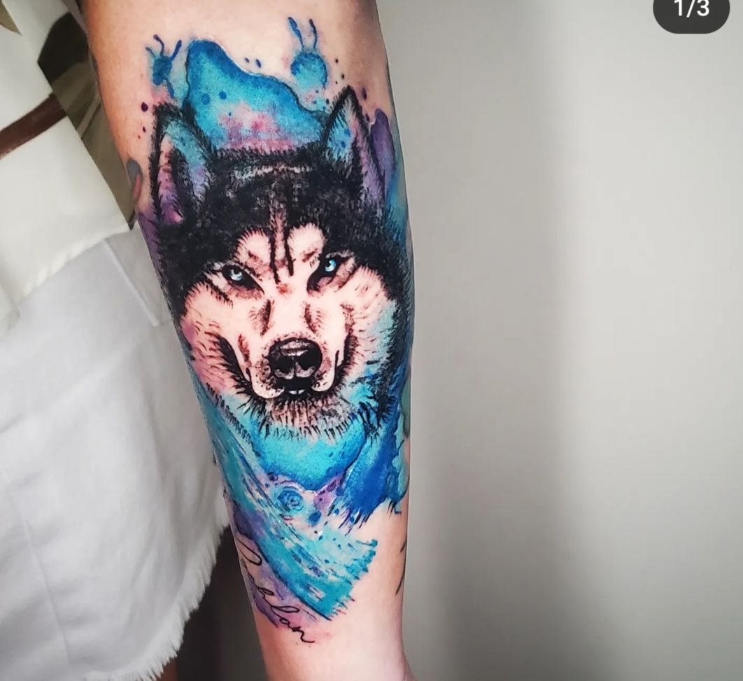 Wolf Animal & Blue Water Color Tattoo By Ari Elise, A Guest Tattoo Artist At Iron Palm Tattoos In Atlanta. Ari comes to us from Hart & Huntington Tattoo Company in Orlando Florida. She's available for booking in Aug 2023. Call 404-973-7828 or stop by for a free consultation. Walk ins are welcome.