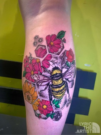 Bumble bee & Flowers Abstract Art Tattoo by Lyric TheArtist at Iron Palm Tattoos In Atlanta. Tattoo done for Sunflower Skies IG: @sunflower.skyes. We like how roses, sunflowers, and lotus flowers are present below the bee as it would be in nature. We think this tattoo symbolizes life or new beginnings. We're open late night until 2AM most nights. Call 404-973-7828 or stop by for a free consultation. Walk-Ins are welcome during business hours.