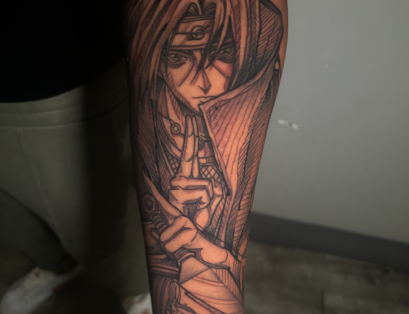 Itachi Uchiha Naruto Manga Anime Tattoo in Black Ink by Lyric TheArtist. Itachi is a popular character in the Naruto Manga anime serious created by Masashi Kishimoto. He's both a charismatic leader of his village and an antagonist in the japonense animation series. We're open late night until 2AM. Call 404-973-7828 stop by for a free consultation. Walk ins are welcome.