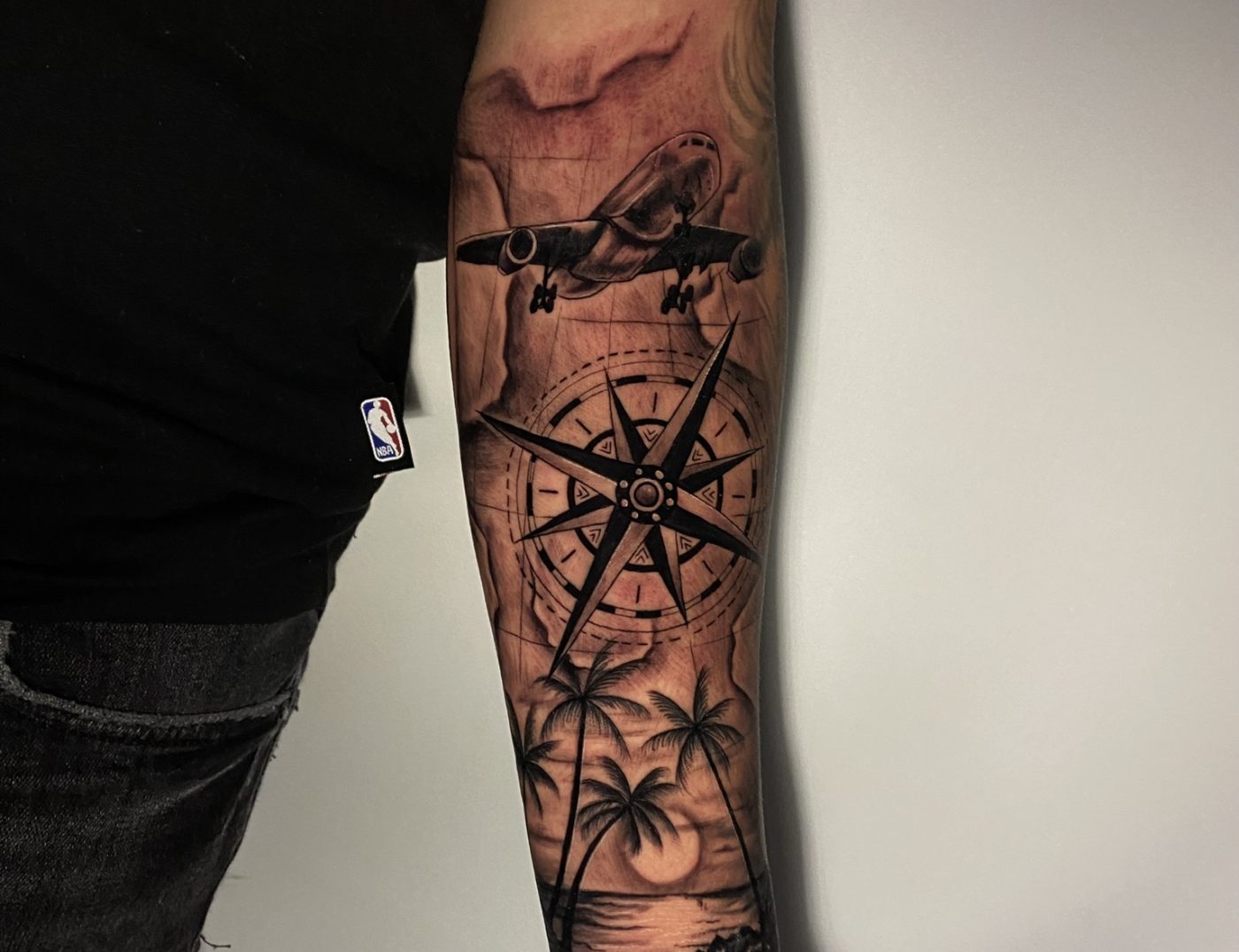 Airplane, Compass & Beach Blackwork Tattoo By Rene Cristobal. Rene inked this tattoo for a customer that loves to travel. Call 404-973-7828 or stop by for a free consultation.
