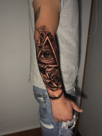 'All Seeing Eye' AKA "The Eye of Providence" And Rose Surrealism Blackwork Tattoo By Rene Cristobal. Rene is a resident artist at Iron Palm Tattoos. He is from Concepcion, Chile and is fluent in Spanish. The "Eye of Providence" is usually depicted in a triangle to signal an all seeing deity peering into our world from other dimensions.