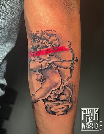 Classy Cupid Black & Gray Tattoo By Funk Tha World at Iron Palm Tattoos in downtown Atlanta, Georgia. Funk is a senior resident tattoo artist at Iron Palm. Call 404-973-7828 or stop by for a free consultation. Walk ins are welcome.
