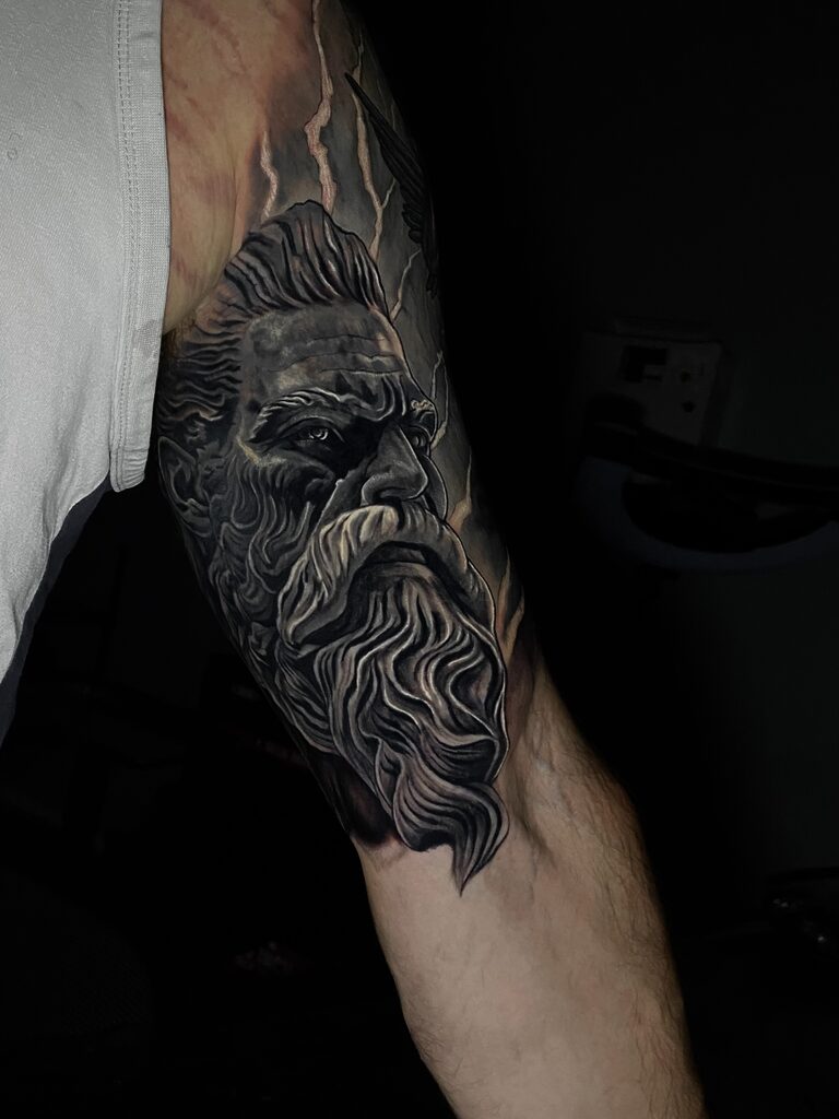 Zeus Black & Gray Cover-Up Sleeve Tattoo by Rene Cristobal. Rene inked this cool cover up for an Airman from Alabama. Iron Palm is Atlanta's only late night tattoo shop. We're open from 1pm -2am most nights. Call 404-973-7828 or stop by for a free consultation. Walk ins are accepted.