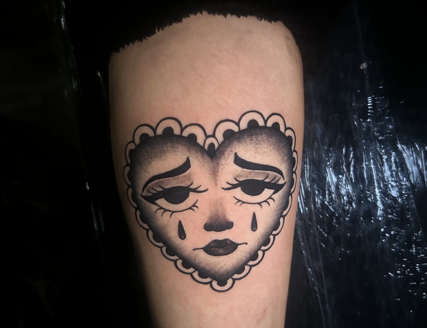"Crying Face Heart" By Lyric TheArtist At Iron Palm Tattoos. The Crying Face Heart is used to symbolize a romantic relationship that no longer burns bright or feelings of betrayal in an enduring relationship.