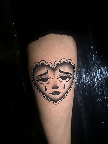 "Crying Face Heart" By Lyric TheArtist At Iron Palm Tattoos. The Crying Face Heart is used to symbolize a romantic relationship that no longer burns bright or feelings of betrayal in an enduring relationship.