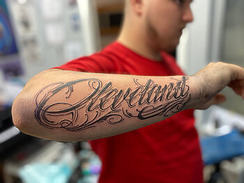 "Cleveland" Blackwork Lettering Tattoo By Majesty at Iron Palm Tattoos. Majesty is a new resident artist at Iron Palm and comes to us from Cleveland, Ohio. Iron Palm is Atlanta's only late night tattoo shop. Call 404-973-7828 or stop by for a free consultation.