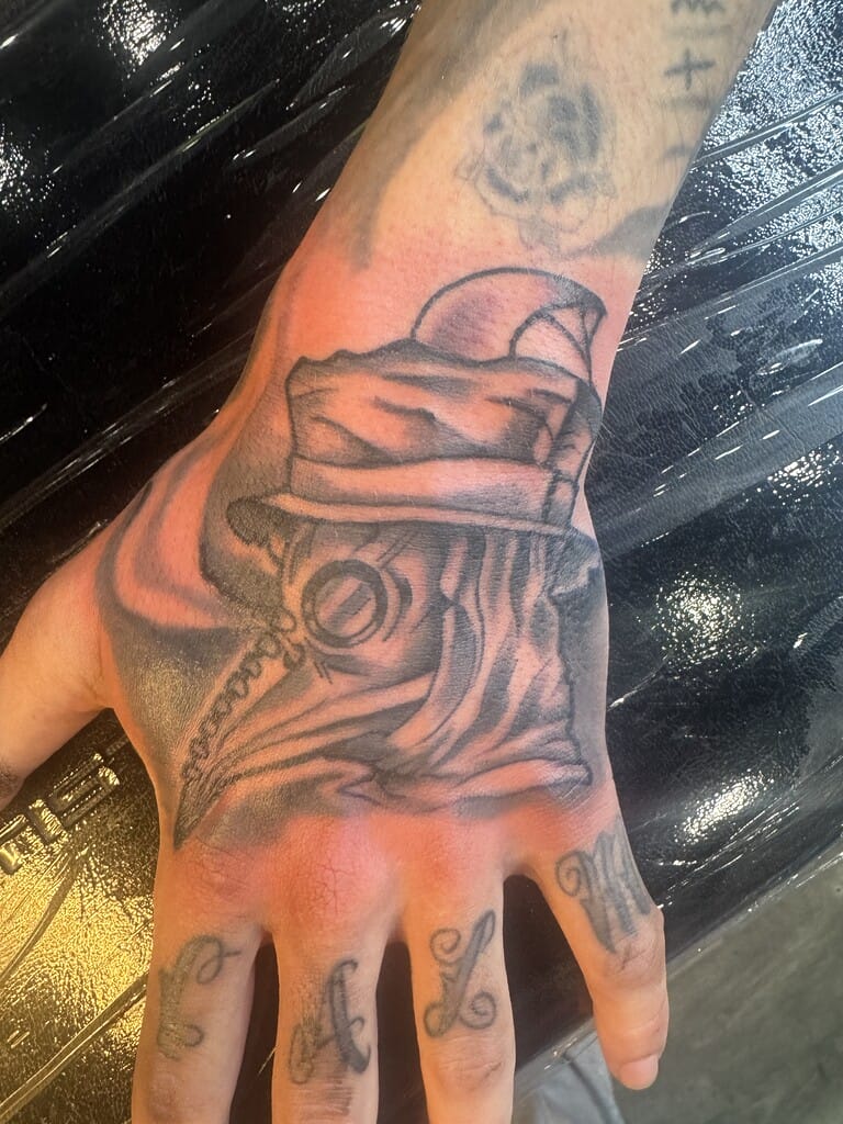 Black and gray Bart Simpson portrait tattoo on forearm with shaded background