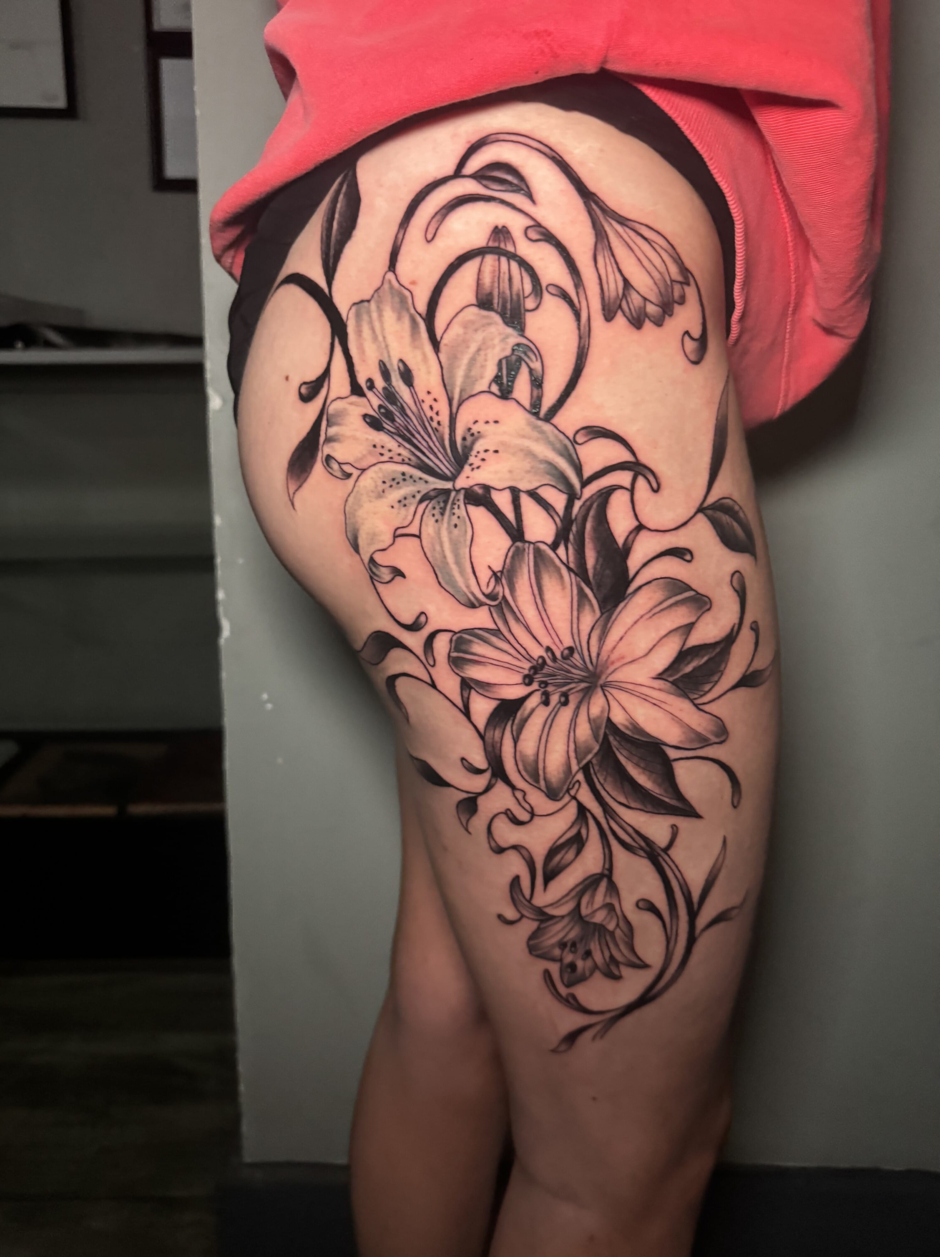Black And Gray Floral Thigh Tattoo By Moe